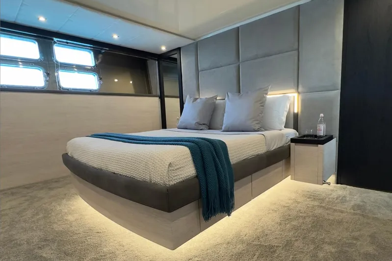 Deea II Yacht Photos Pics Luxurious bedroom interior on 2009 Cerri Cantieri Navali 102 yacht, featuring modern design and ambient lighting.