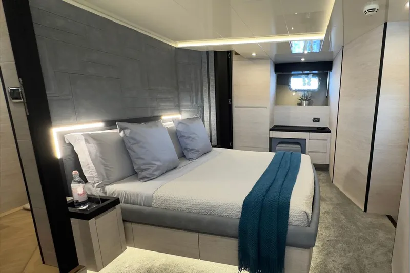 Deea II Yacht Photos Pics Luxurious bedroom interior on 2009 Cerri Cantieri Navali 102 yacht, featuring modern design and cozy ambiance.