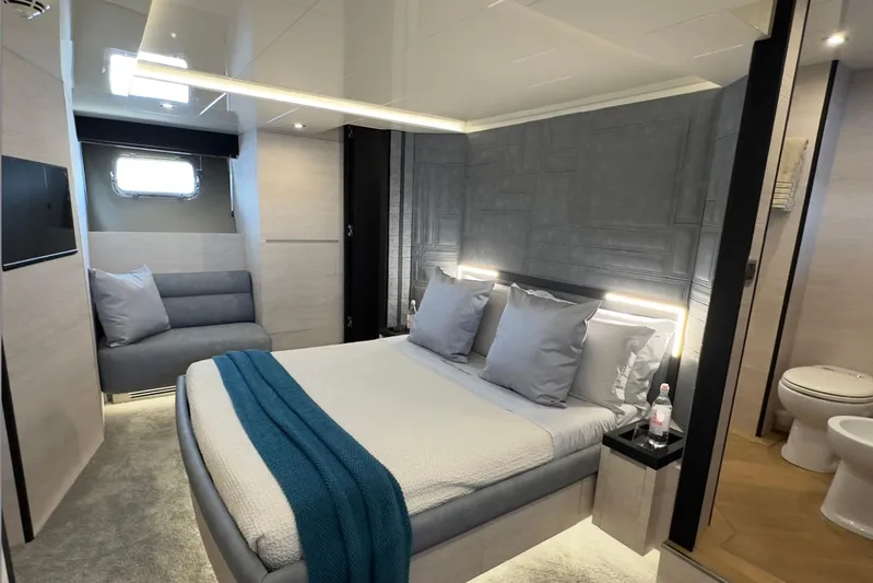 Deea II Yacht Photos Pics Luxurious bedroom interior on 2009 Cerri Cantieri Navali 102 yacht, featuring modern design and cozy ambiance.