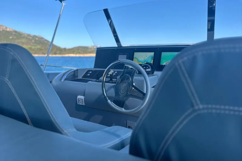 Deea II Yacht Photos Pics Helm of 2009 Cerri Cantieri Navali 102 yacht with navigation screens and steering wheel.