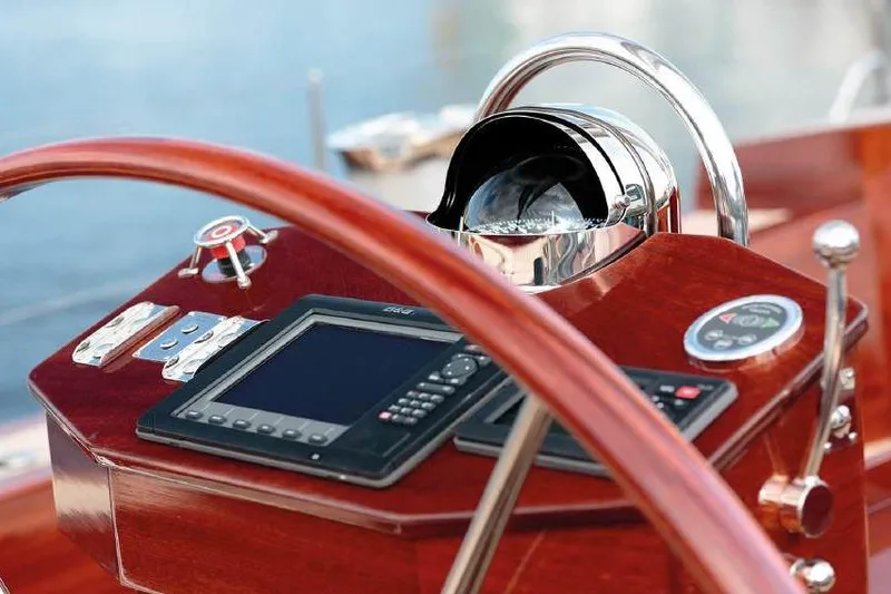 Spirit Of Galatea Yacht Photos Pics Cockpit of 2014 Spirit Yachts R74 with navigation instruments and wooden steering wheel.