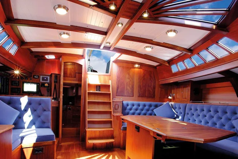 Spirit Of Galatea Yacht Photos Pics Luxurious interior of 2014 Spirit Yachts R74 with wood finish and blue seating.