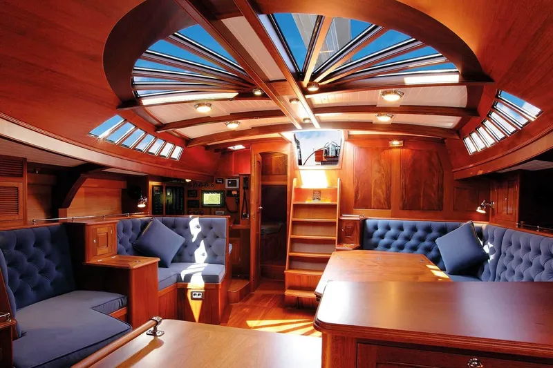 Spirit Of Galatea Yacht Photos Pics Luxurious interior of 2014 Spirit Yachts R74, featuring elegant woodwork and plush seating.