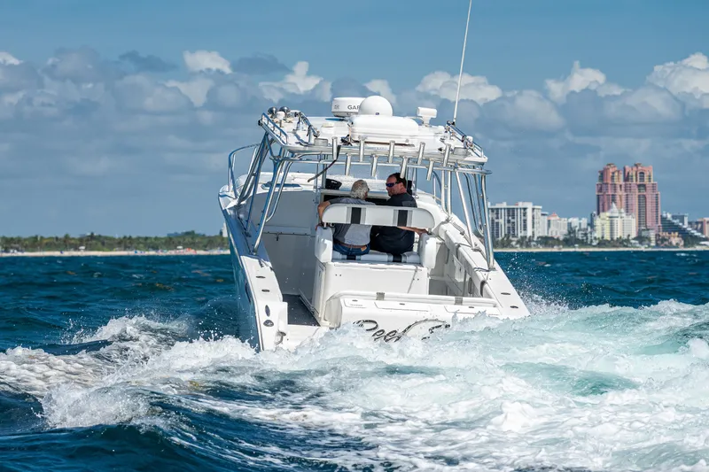  Yacht Photos Pics 2007 Marlin Yachts 42 cruising on the ocean near a city skyline.