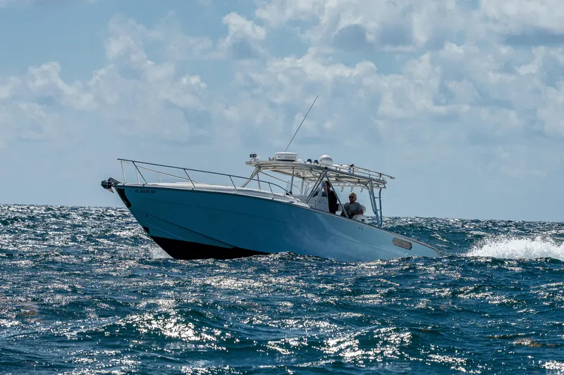  Yacht Photos Pics 2007 Marlin Yachts 42 cruising on open water under a partly cloudy sky.
