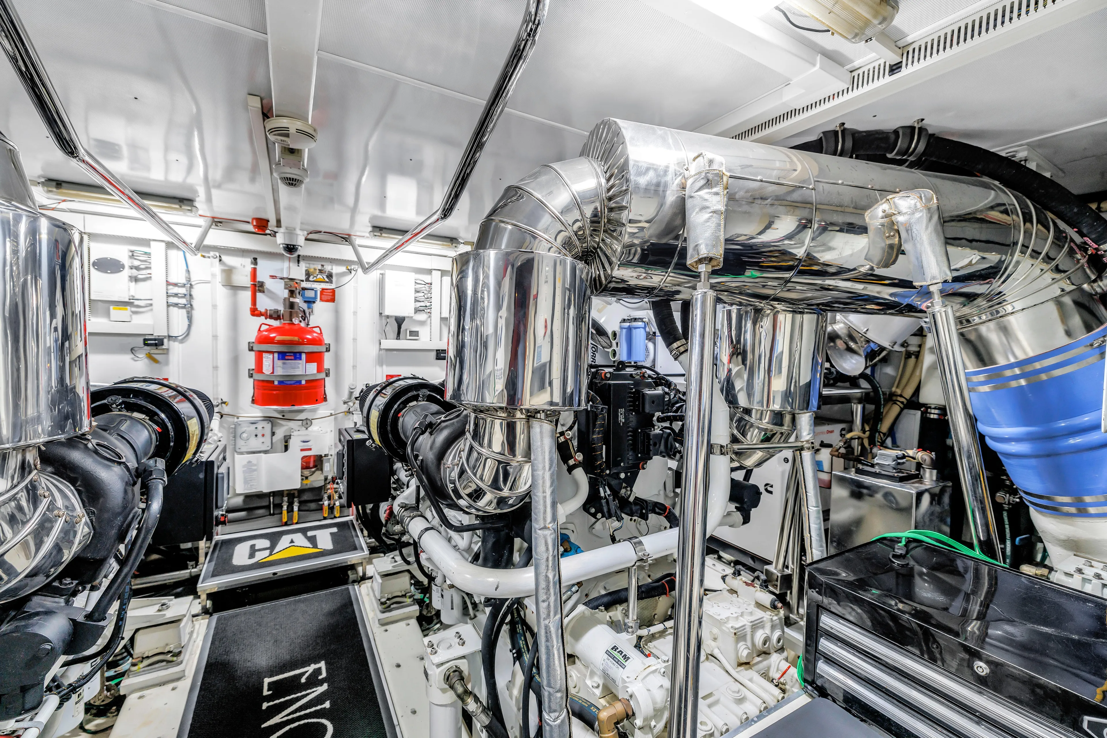 Encore Yacht Photos Pics Engine room of 2015 Horizon E88 yacht with CAT machinery and fire safety equipment.