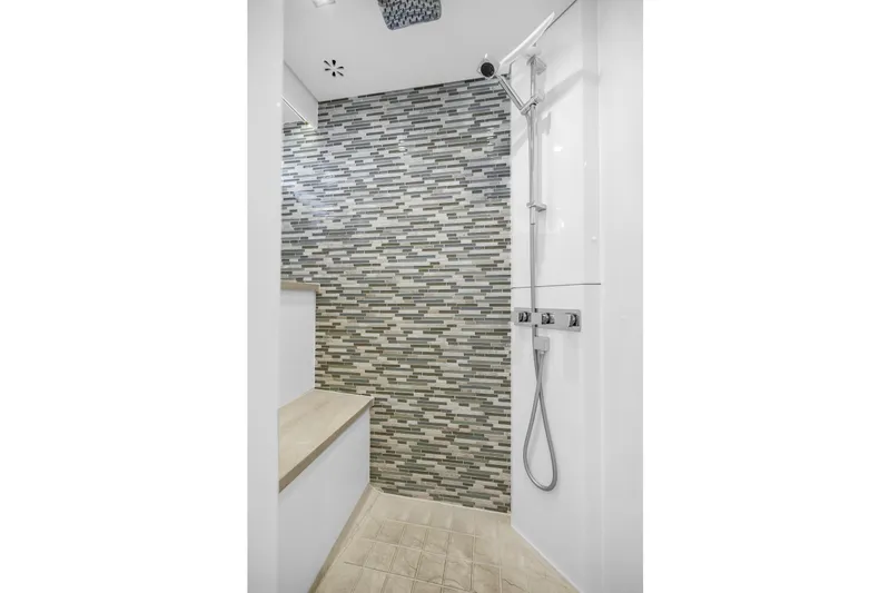 Encore Yacht Photos Pics Modern shower with mosaic tile wall and sleek fixtures on Horizon E88 yacht, 2015 model.