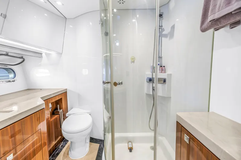 Encore Yacht Photos Pics Luxurious bathroom in 2015 Horizon E88 yacht with modern shower and wooden cabinetry.