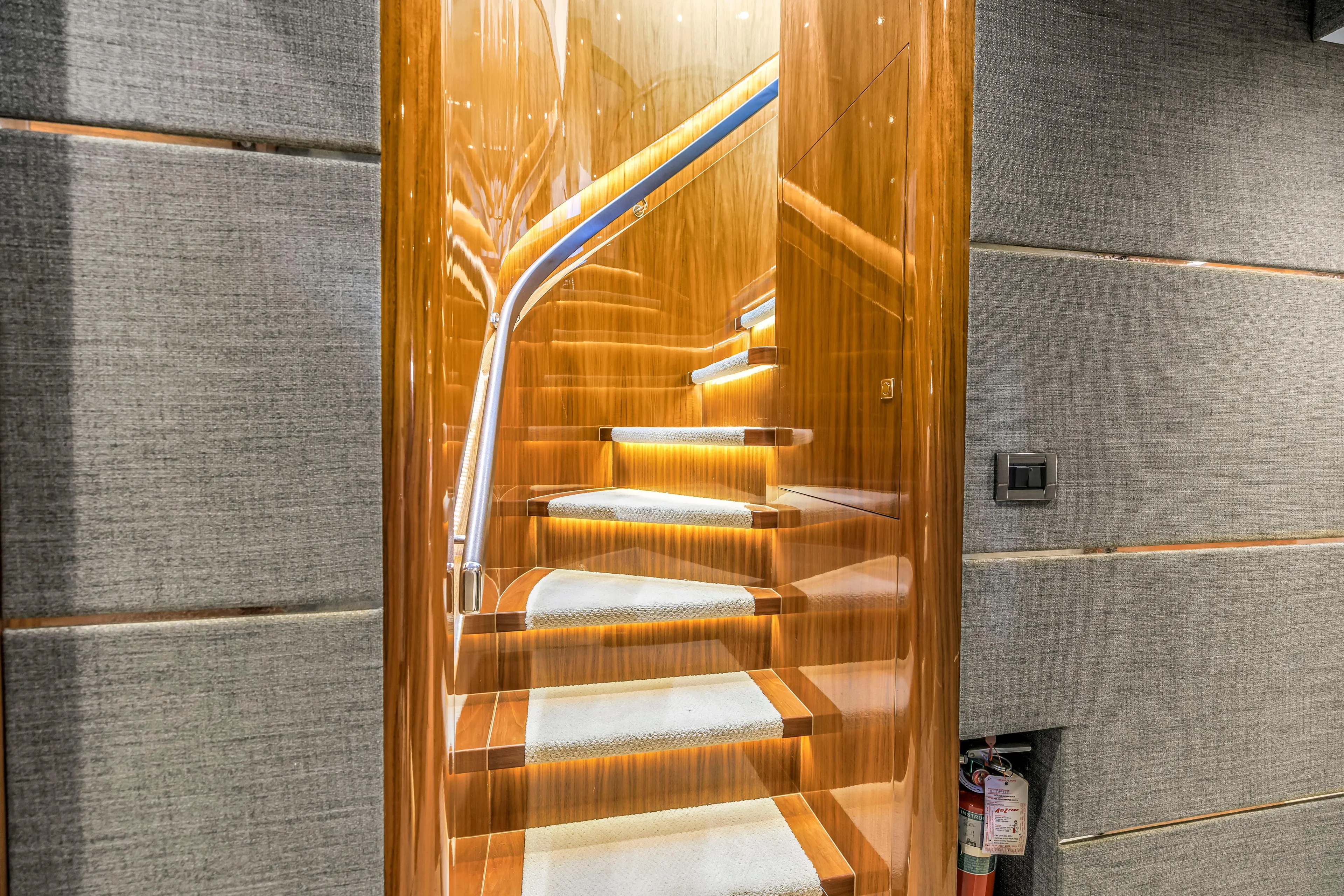 Encore Yacht Photos Pics Luxurious wooden staircase with LED lighting on a 2015 Horizon E88 yacht.