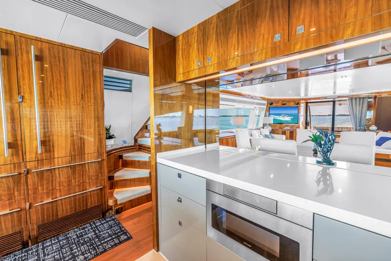 Encore Yacht Photos Pics Luxurious interior of 2015 Horizon E88 yacht with modern kitchen and elegant wood finishes.