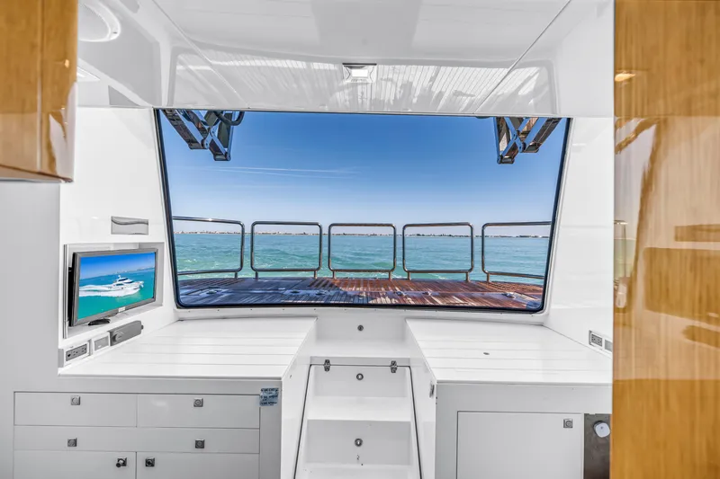 Encore Yacht Photos Pics Interior view of 2015 Horizon E88 yacht with ocean backdrop and TV display.