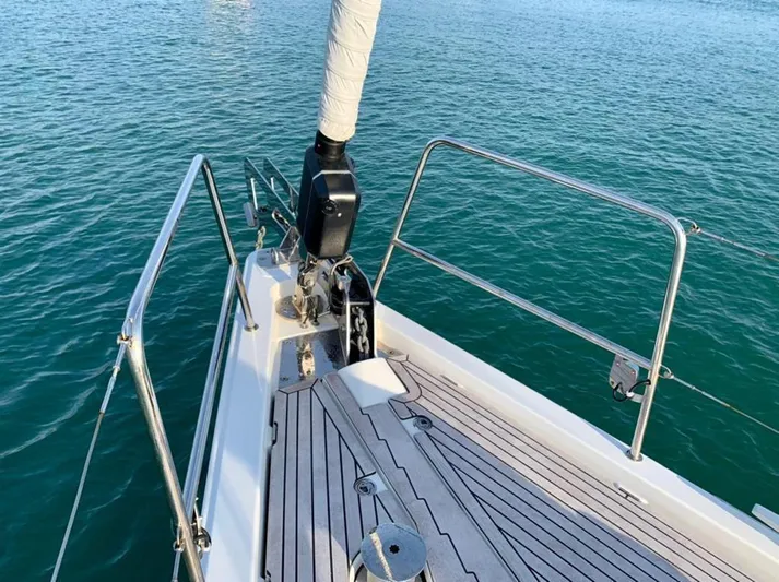  Yacht Photos Pics Jeanneau 64 sailboat deck, 2021 model, with teak flooring and stainless steel railings.