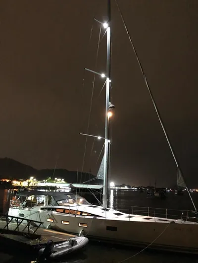  Yacht Photos Pics Jeanneau 64 yacht, 2021 model, illuminated at night in a marina setting.