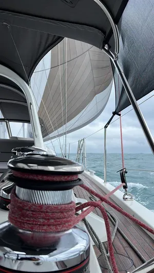  Yacht Photos Pics 2021 Jeanneau 64 sailboat on open sea, showcasing deck and sails.