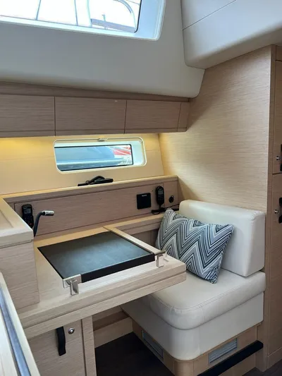  Yacht Photos Pics Interior of 2021 Jeanneau 64 yacht with modern seating and desk area.
