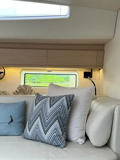  Yacht Photos Pics Interior of 2021 Jeanneau 64 yacht with stylish cushions and modern decor.