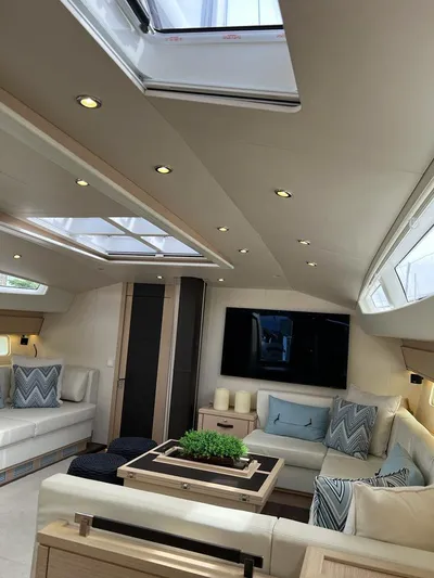  Yacht Photos Pics Luxurious interior of a 2021 Jeanneau 64 yacht with modern furnishings and skylights.