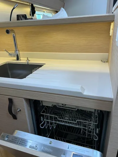  Yacht Photos Pics Modern kitchen in 2021 Jeanneau 64 yacht with sink and open dishwasher.