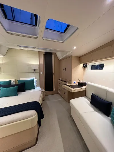 Yacht Photos Pics Luxurious interior of 2021 Jeanneau 64 yacht with elegant furnishings and skylights.