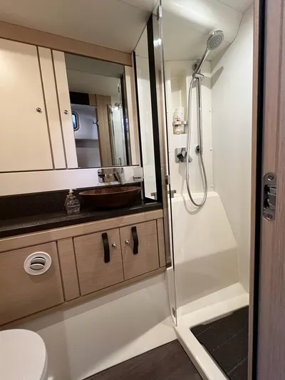  Yacht Photos Pics Bathroom interior of 2021 Jeanneau 64 yacht with shower and vanity.