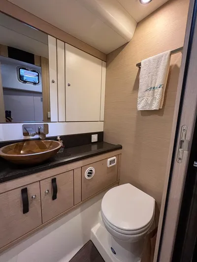  Yacht Photos Pics Luxurious bathroom in 2021 Jeanneau 64 yacht with modern fixtures and elegant design.