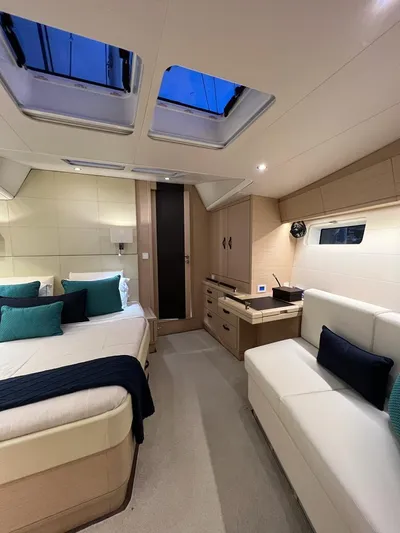  Yacht Photos Pics Luxurious interior of 2021 Jeanneau 64 yacht with elegant furnishings and skylights.