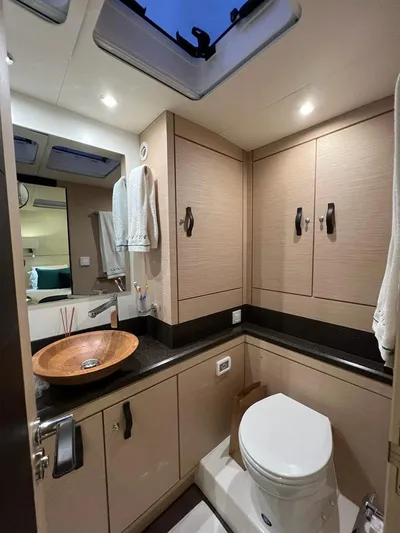  Yacht Photos Pics Luxurious bathroom in 2021 Jeanneau 64 yacht with modern fixtures and elegant design.