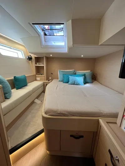  Yacht Photos Pics Luxurious cabin interior of 2021 Jeanneau 64 yacht with skylight and elegant bedding.