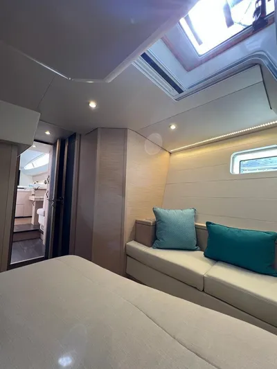  Yacht Photos Pics Luxurious interior of 2021 Jeanneau 64 yacht with modern furnishings and skylight.