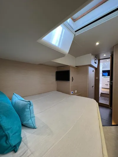  Yacht Photos Pics Luxurious cabin interior of 2021 Jeanneau 64 yacht with skylight and modern amenities.