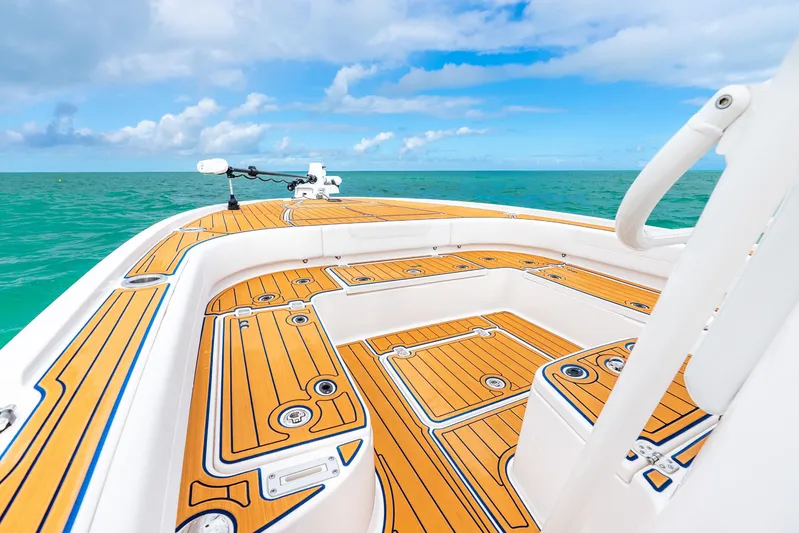  Yacht Photos Pics 2024 Caymas 281 HB boat deck with teak flooring, ocean view, and clear blue sky.