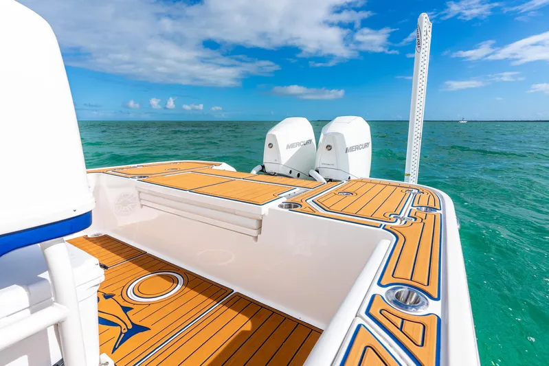  Yacht Photos Pics 2024 Caymas 281 HB boat with dual Mercury engines on turquoise water.