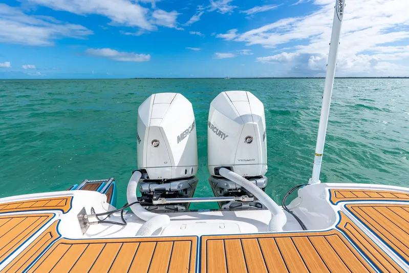  Yacht Photos Pics 2024 Caymas 281 HB boat with dual Mercury engines on turquoise water.