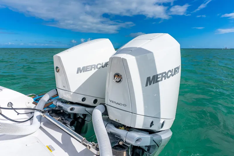  Yacht Photos Pics 2024 Caymas 281 HB boat with dual Mercury outboard engines on turquoise water.