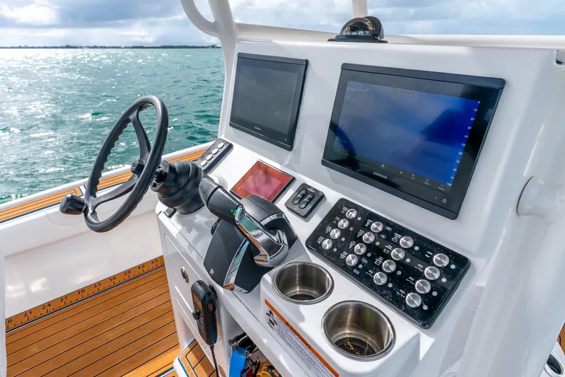  Yacht Photos Pics 2024 Caymas 281 HB boat dashboard with steering wheel and navigation screens.