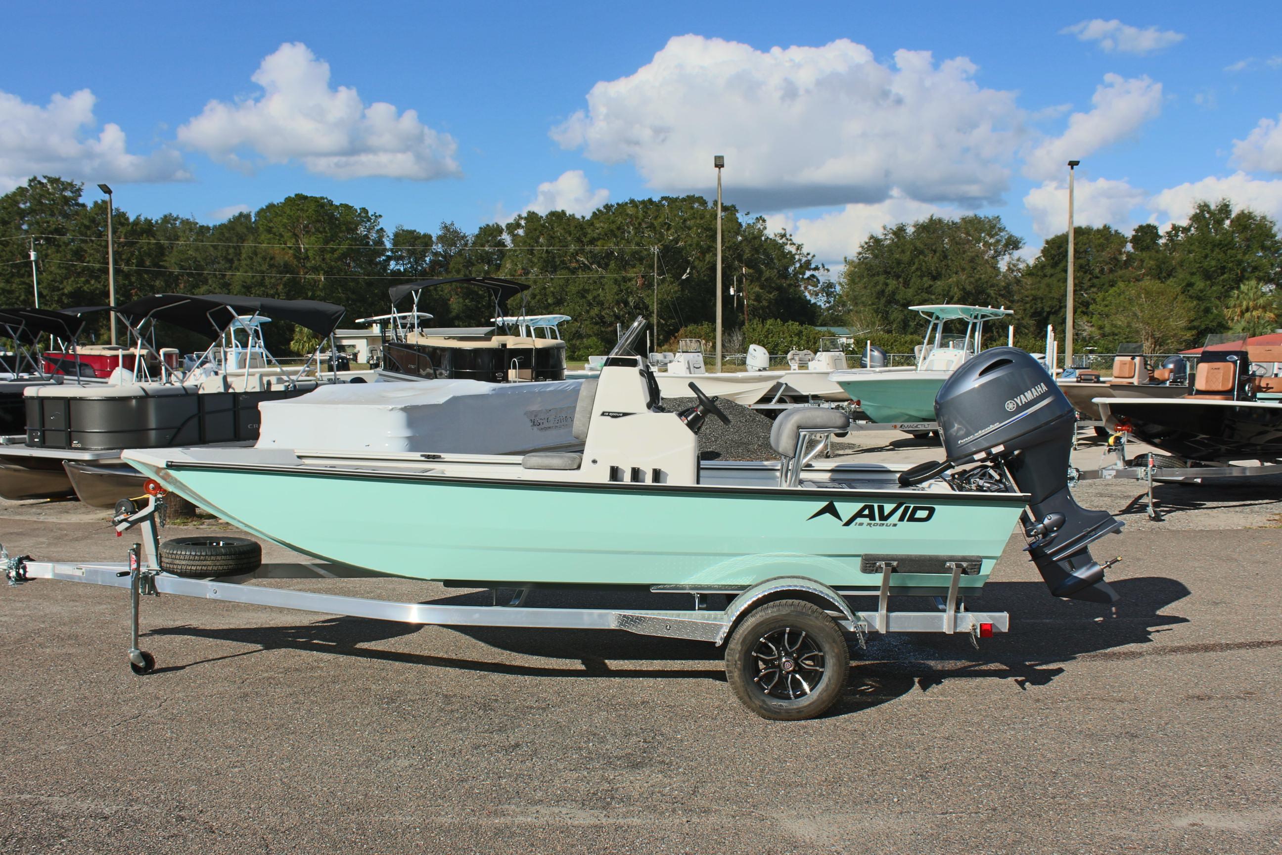 2025 Avid 18 Rogue CC boat on trailer in outdoor showroom.