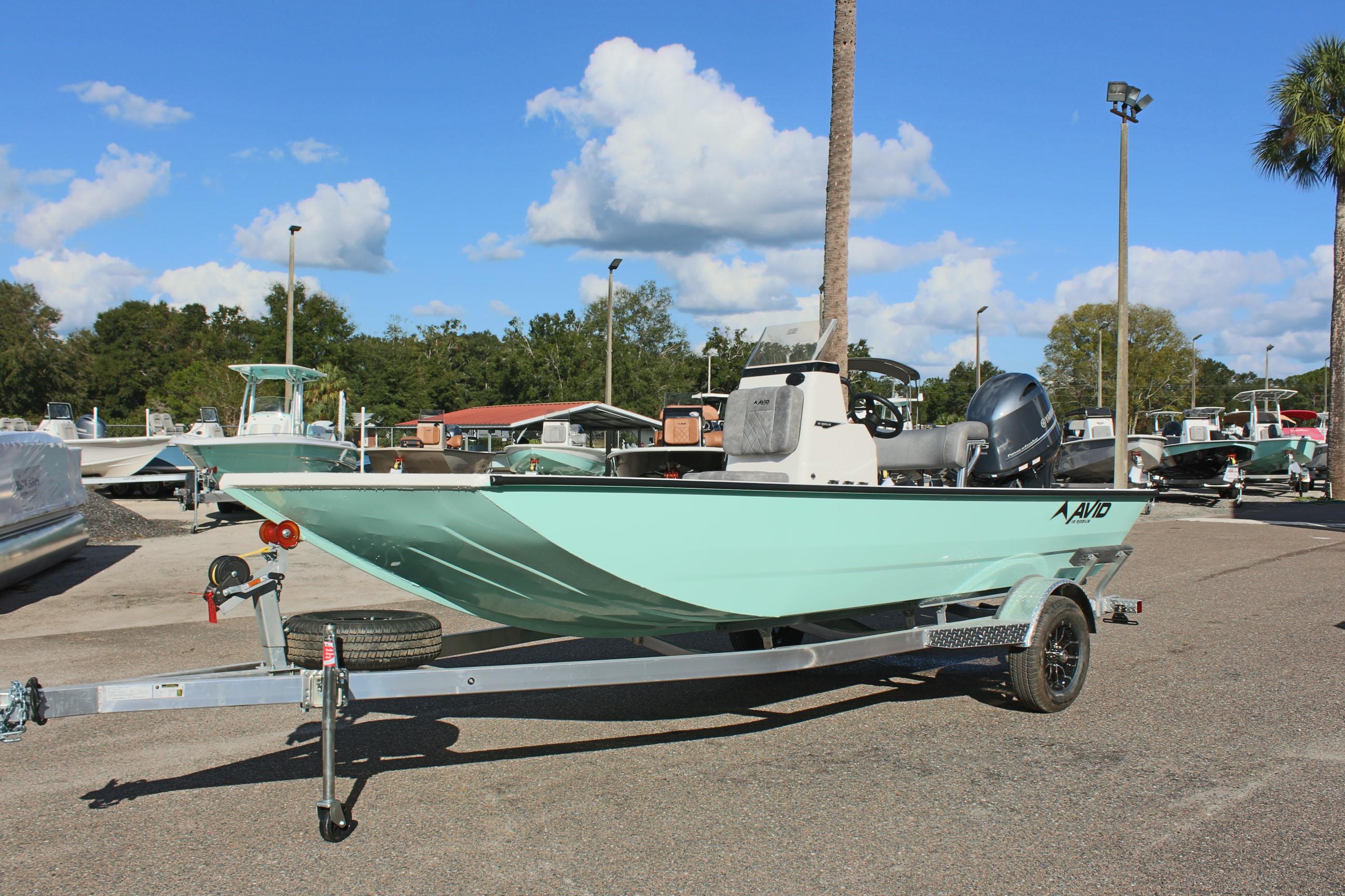 2025 Avid 18 Rogue CC boat on trailer, parked outdoors under blue sky.