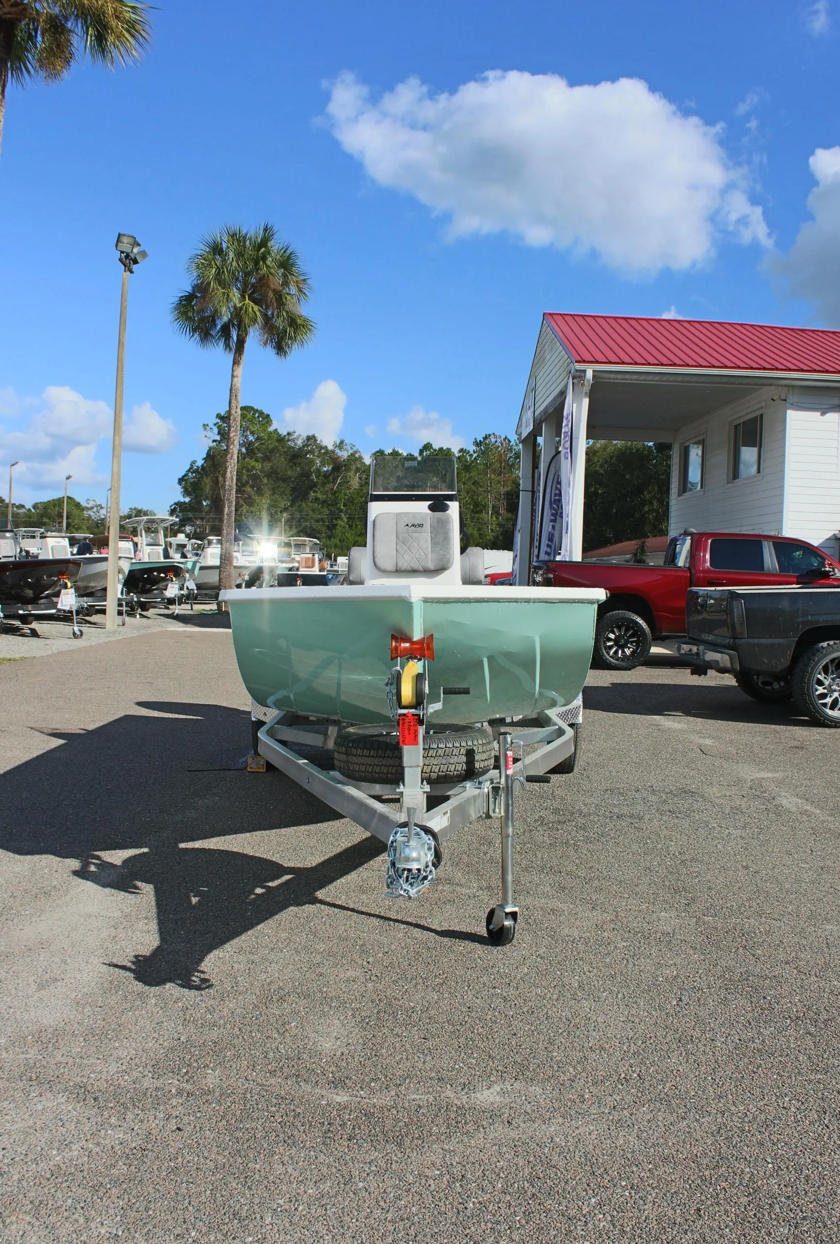 2025 Avid 18 Rogue CC boat on trailer in sunny dealership lot.