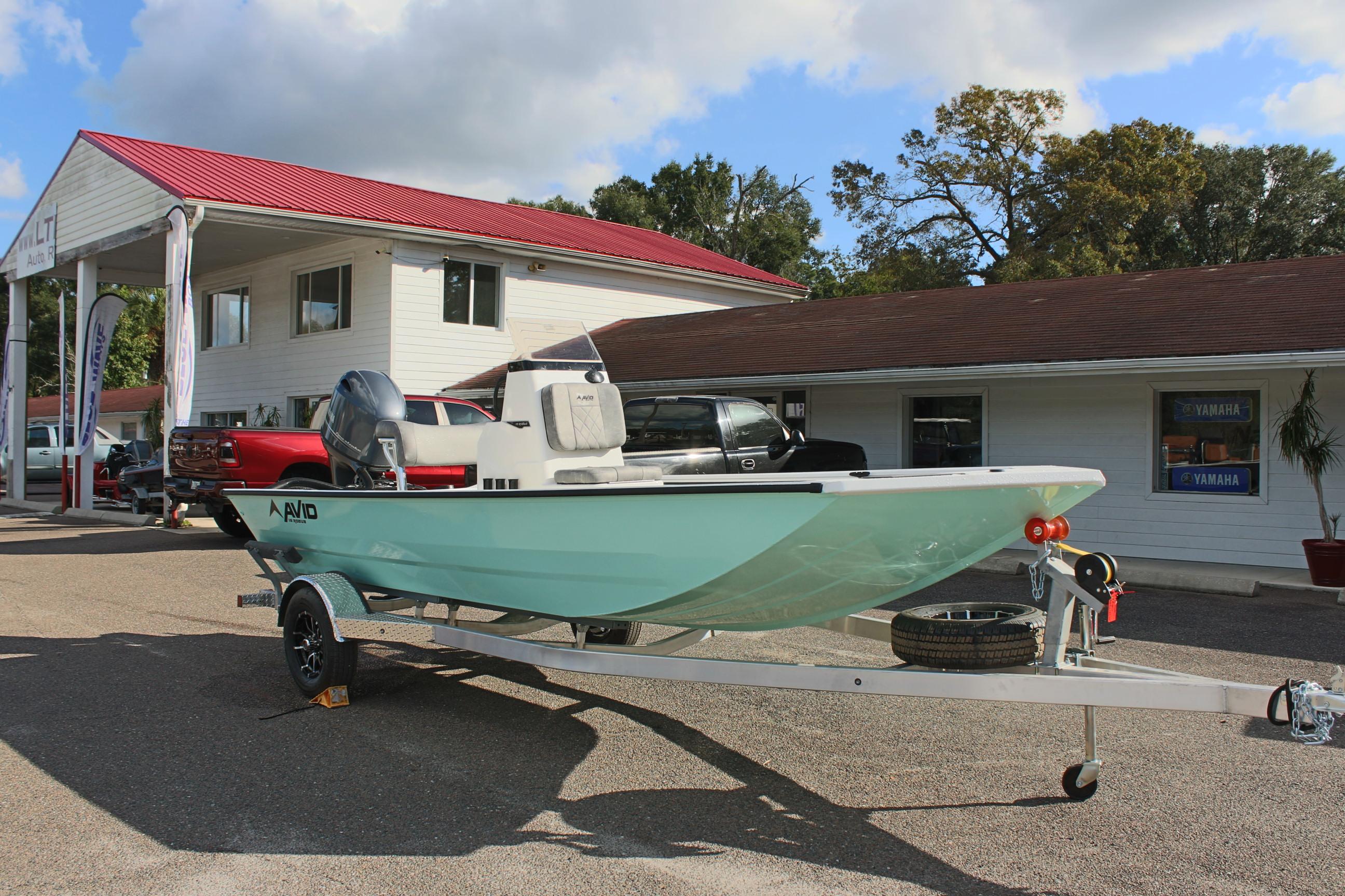 2025 Avid 18 Rogue CC boat on trailer outside dealership.