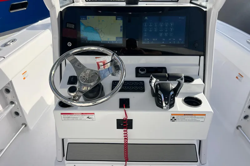  Yacht Photos Pics 2026 Sportsman Heritage 261 Center Console dashboard with steering wheel and navigation screens.