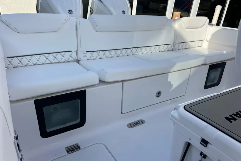  Yacht Photos Pics 2026 Sportsman Heritage 261 Center Console boat with white cushioned seating and storage compartments.