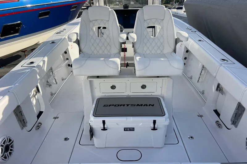  Yacht Photos Pics 2026 Sportsman Heritage 261 Center Console boat interior with white seating and Yeti cooler.