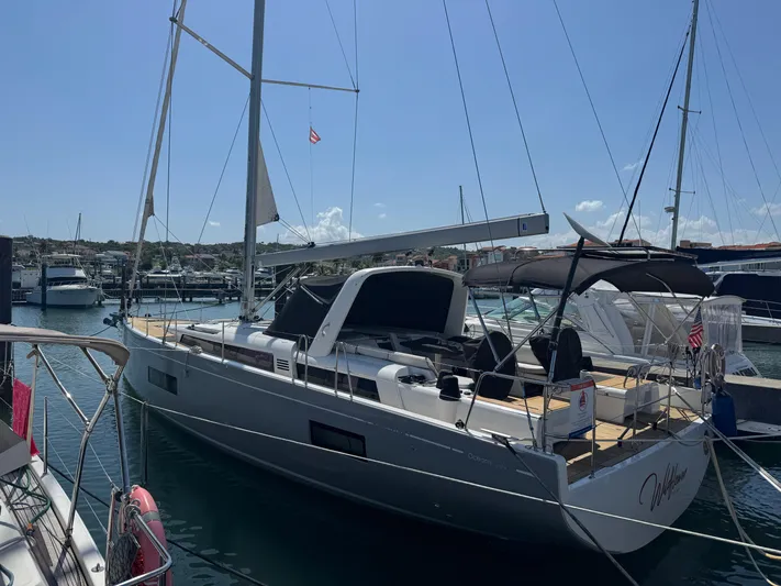 Wildflower Yacht Photos Pics 2021 Beneteau Oceanis Yacht 54 docked at marina under clear sky.