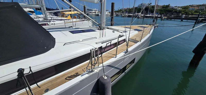 Wildflower Yacht Photos Pics 2021 Beneteau Oceanis Yacht 54 docked in a marina, showcasing sleek design and modern features.