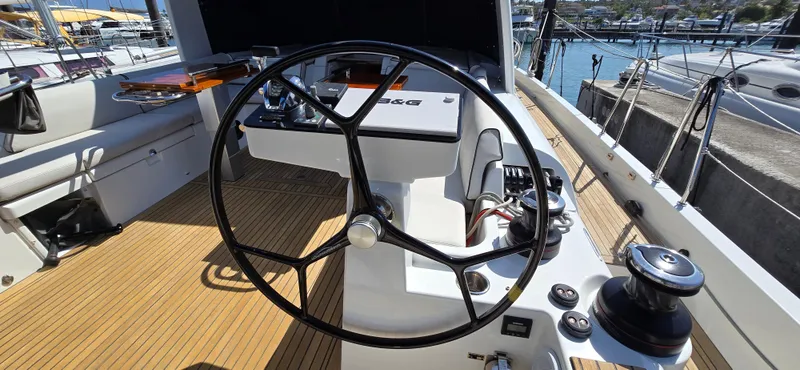 Wildflower Yacht Photos Pics 2021 Beneteau Oceanis Yacht 54 cockpit with steering wheel and navigation controls.