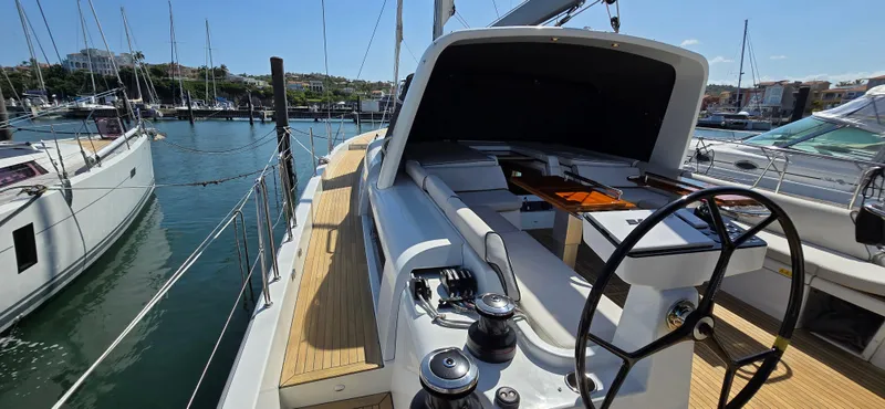 Wildflower Yacht Photos Pics 2021 Beneteau Oceanis Yacht 54 docked, showcasing sleek deck and steering wheel.