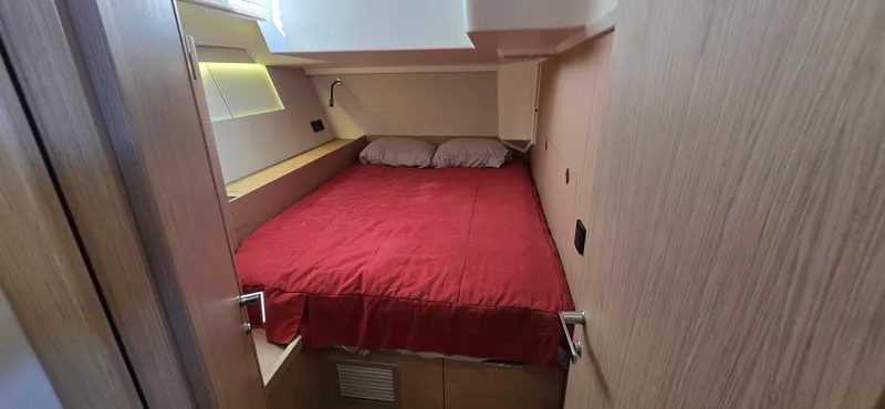 Wildflower Yacht Photos Pics Cozy cabin interior of 2021 Beneteau Oceanis Yacht 54 with red bedding.