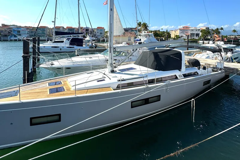 Wildflower Yacht Photos Pics 2021 Beneteau Oceanis Yacht 54 docked in a marina, showcasing sleek design and modern features.