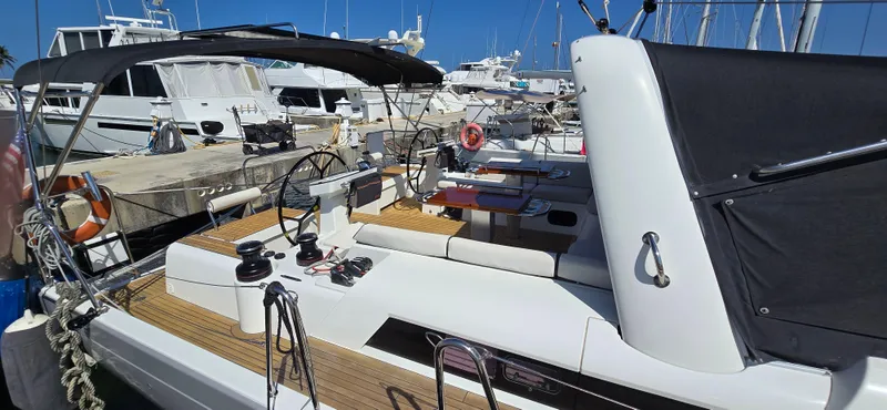 Wildflower Yacht Photos Pics 2021 Beneteau Oceanis Yacht 54 docked, showcasing sleek design and spacious deck.