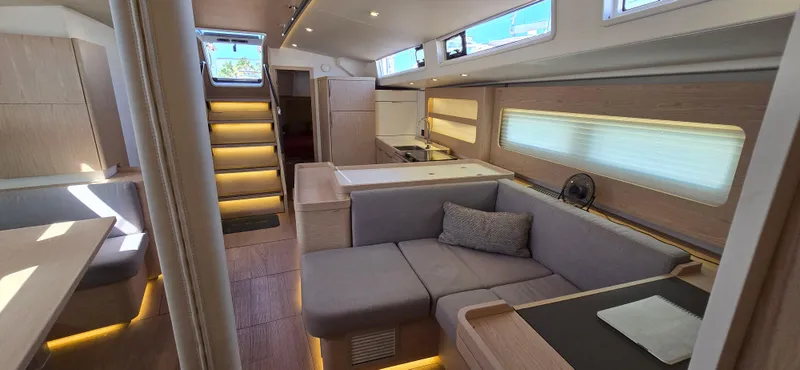 Wildflower Yacht Photos Pics Luxurious interior of 2021 Beneteau Oceanis Yacht 54 with modern furnishings and ambient lighting.